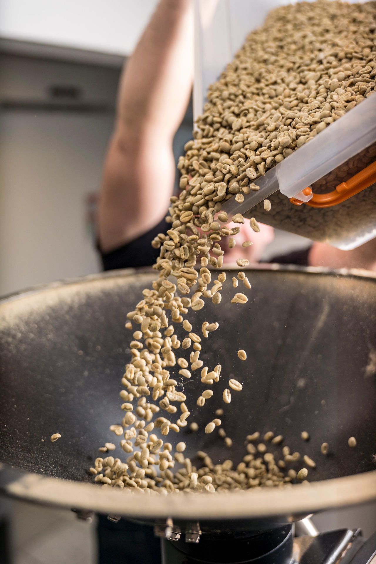 Coffee beans roasting inside a drum roaster