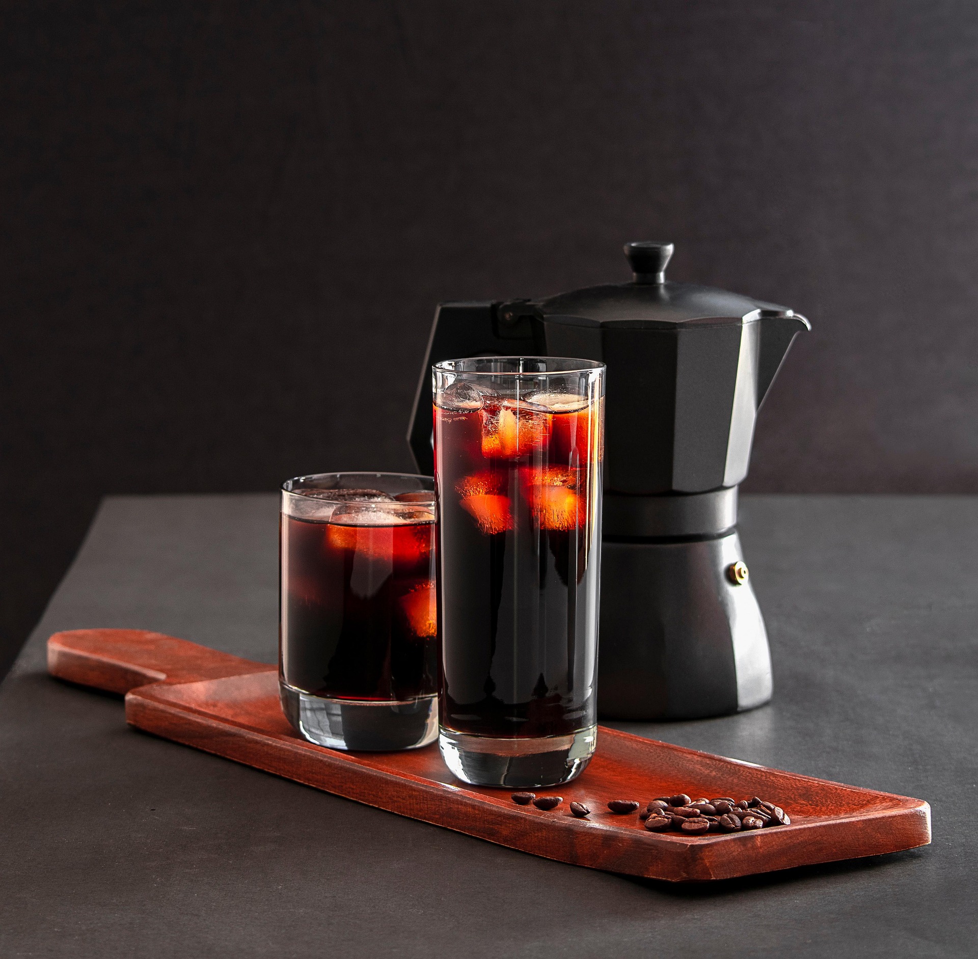 Iced cold brew served over coffee beans