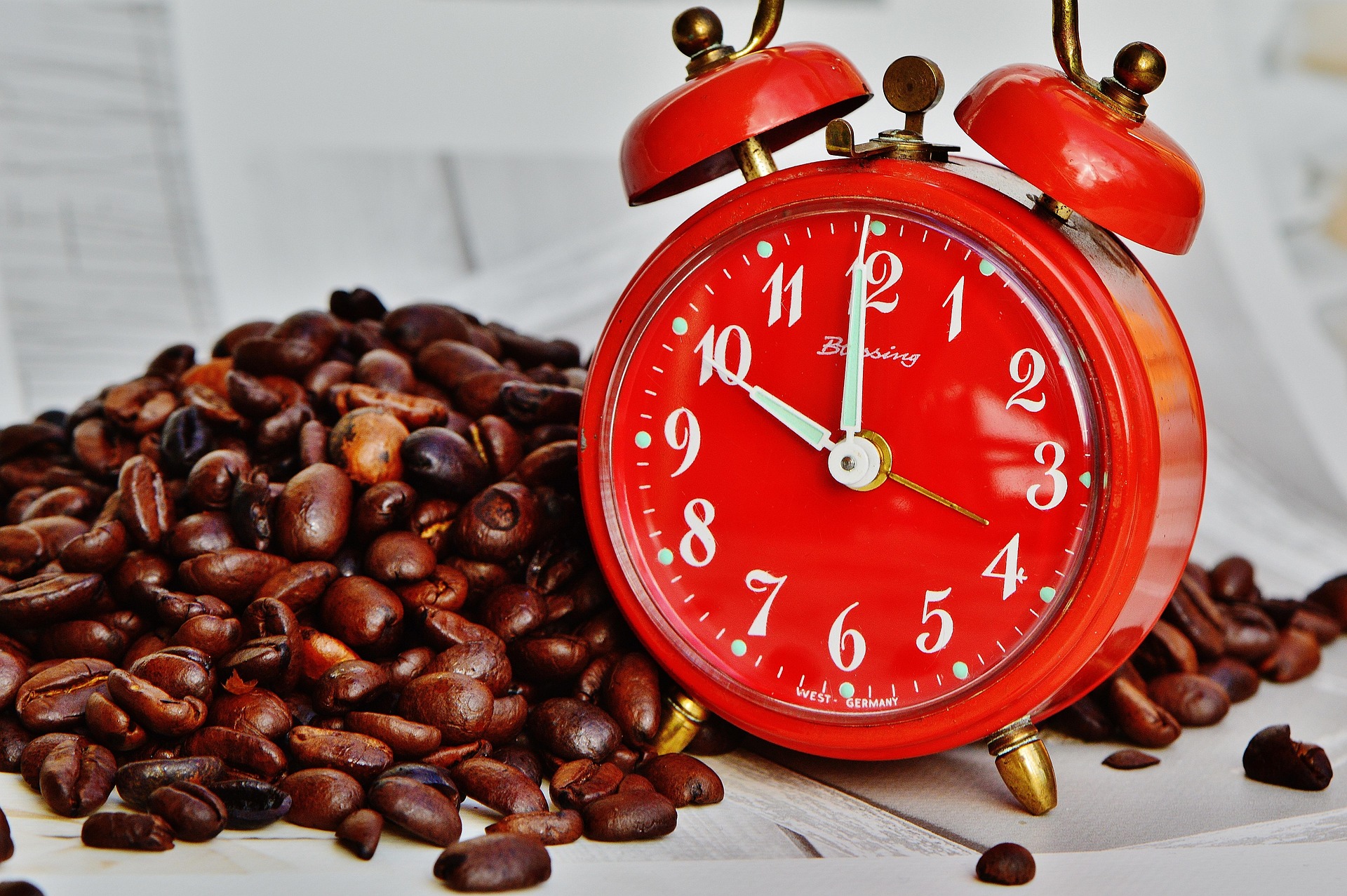 Coffee break setup with cups, croissant, and alarm clock